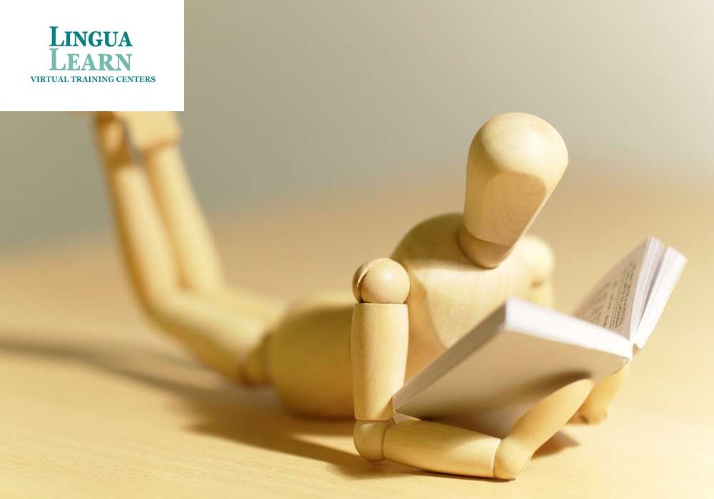 wood figure reading book